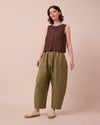 model wears mabel khaki linen trousers left