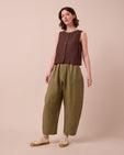 model wears mabel khaki linen trousers left