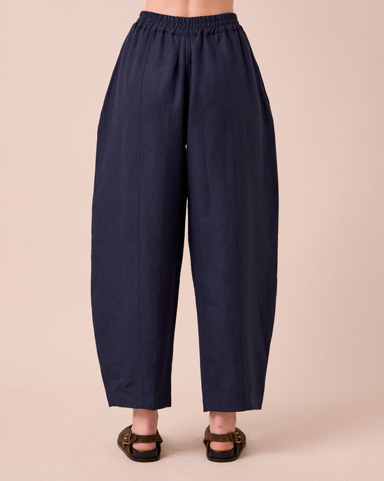 model wears mabel navy linen trousers back