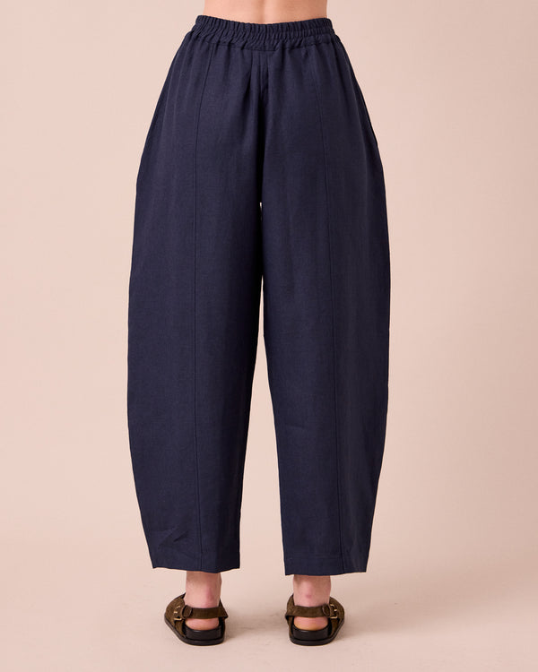 model wears mabel navy linen trousers back