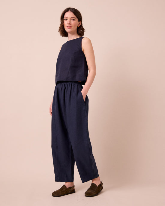 model wears mabel navy linen trousers right