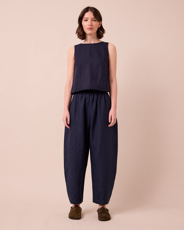 model wears mabel navy linen trousers left
