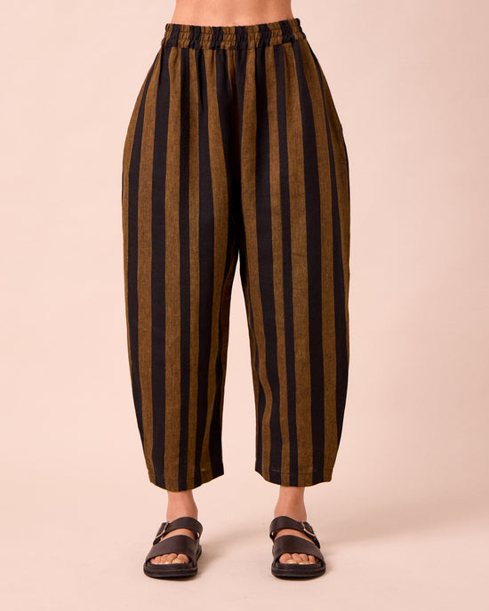 model wears mabel rust stripe linen trousers front