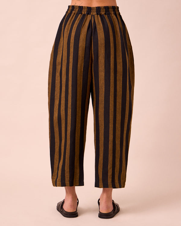 model wears mabel rust stripe linen trousers back