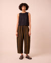model wears mabel rust stripe linen trousers left