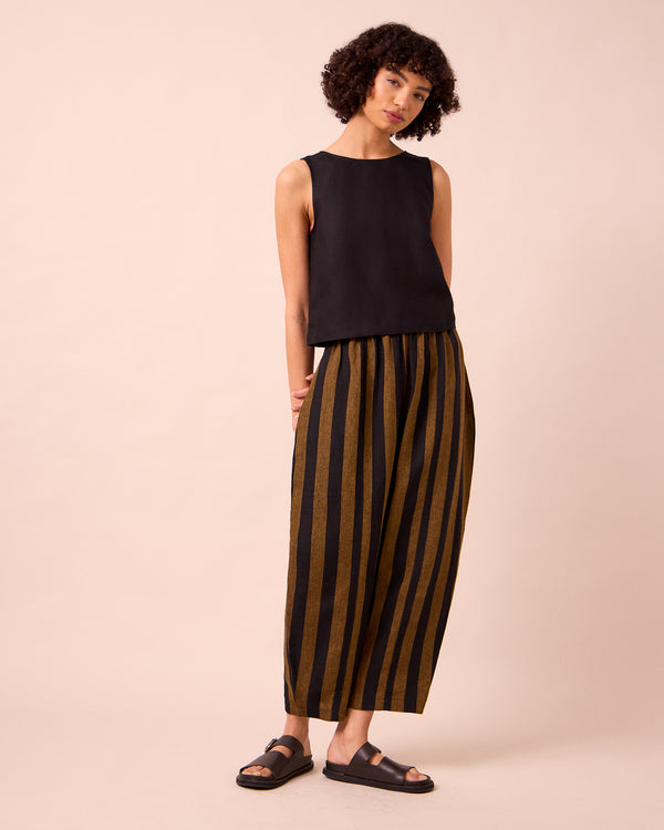 model wears mabel rust stripe linen trousers right