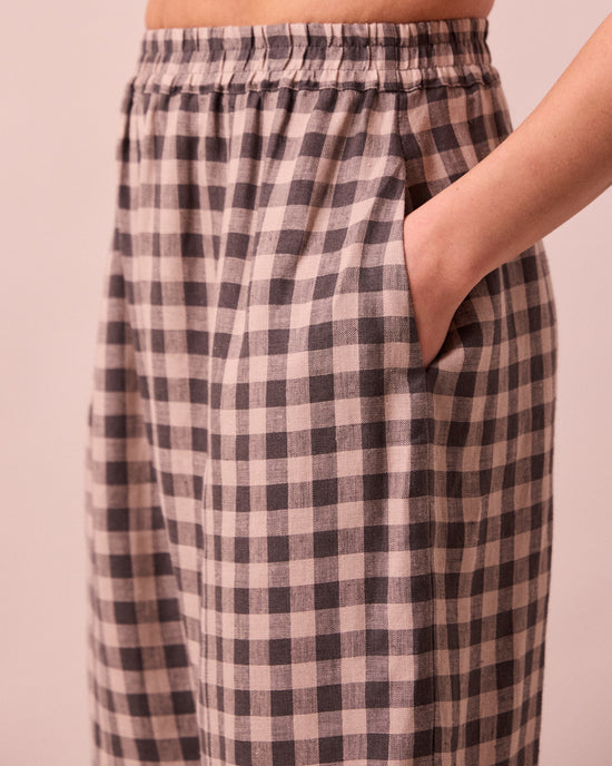 model wears mabel stone gingham linen trousers