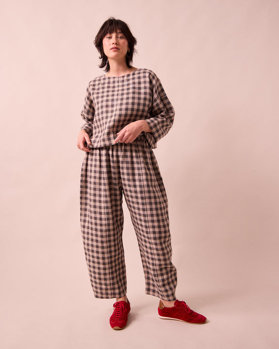 model wears mabel stone gingham linen trousers left