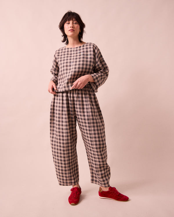 model wears mabel stone gingham linen trousers left