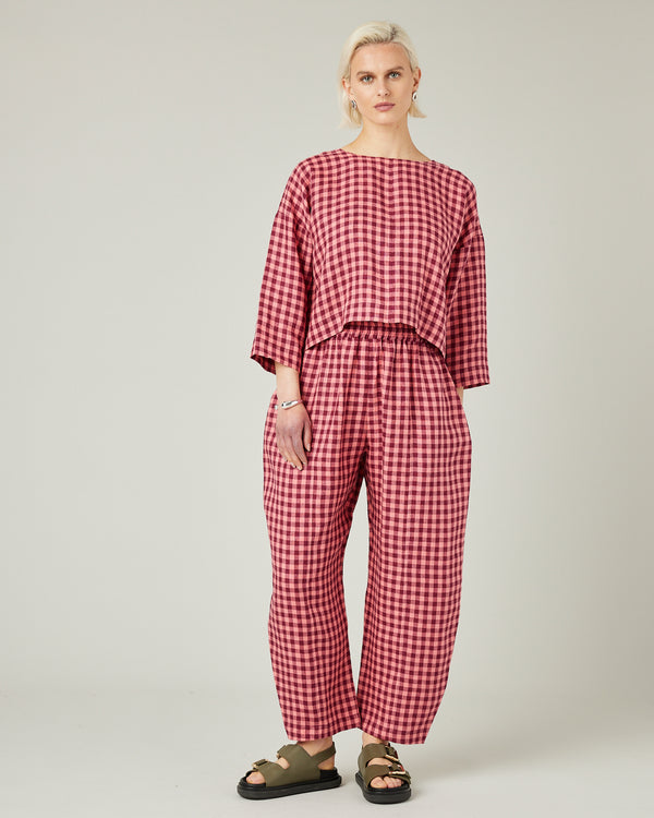 model wears blush gingham mabel linen trousers