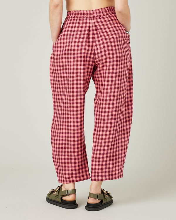 model wears blush gingham mabel linen trousers back