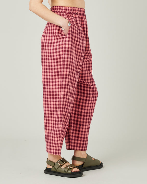 model wears blush gingham mabel linen trousers right