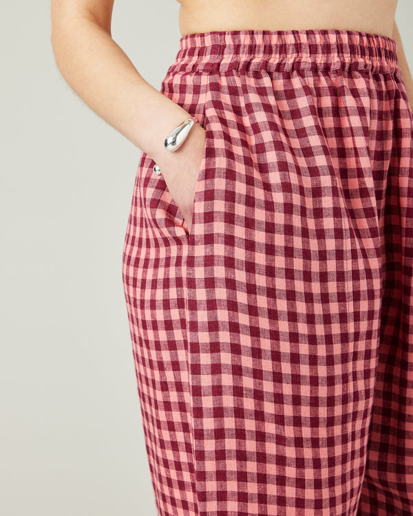 model wears blush gingham mabel linen trousers