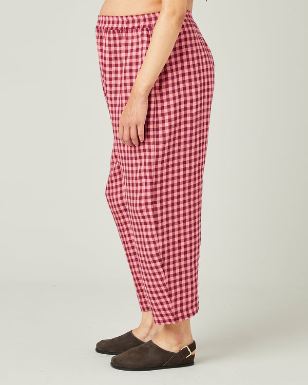 pregnant model wears blush gingham mabel linen trousers