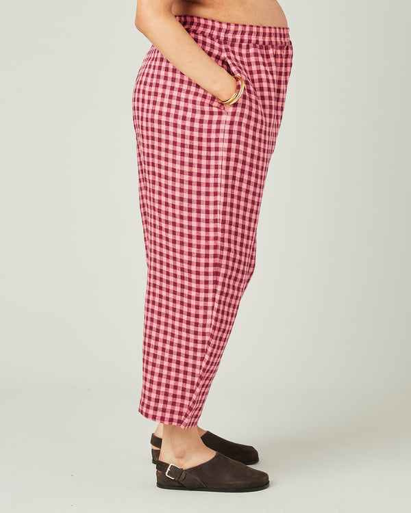 pregnant model wears blush gingham mabel linen trousers