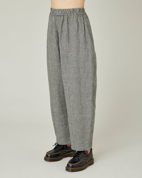 model wears black and stone micro check linen mabel trousers left