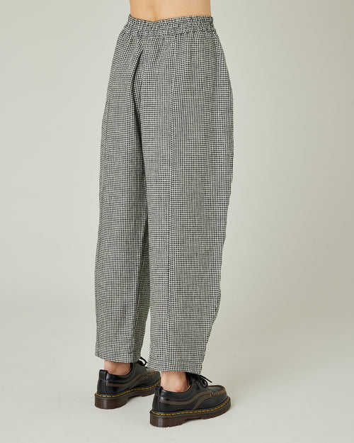 model wears black and stone micro check linen mabel trousers right