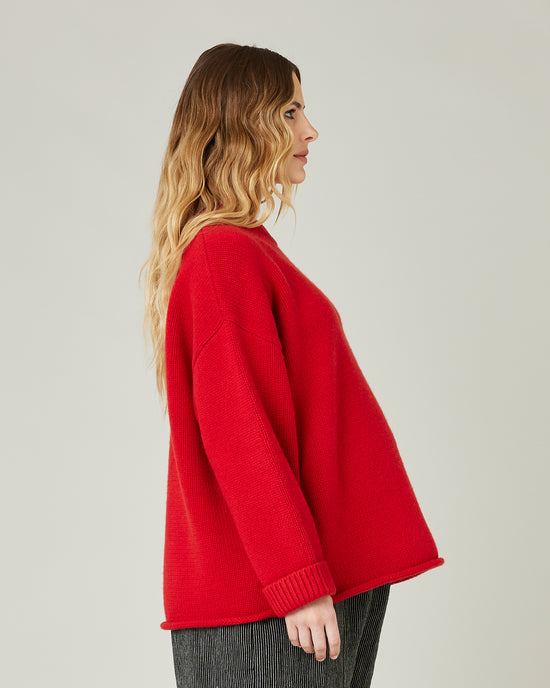 pregnant model wears red knitted luna jumper