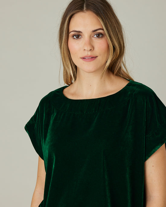 model wears green velvet polly top