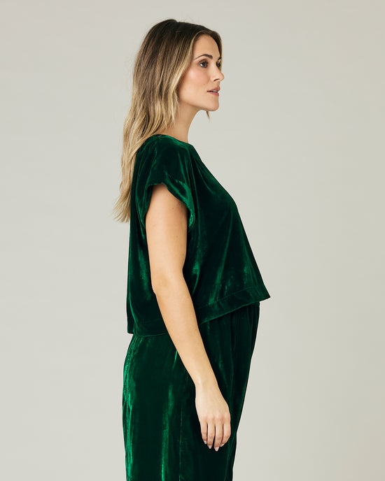 pregnant model wears green velvet polly top and mabel trousers