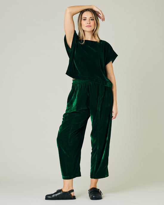 pregnant model wears green velvet polly top and mabel trousers