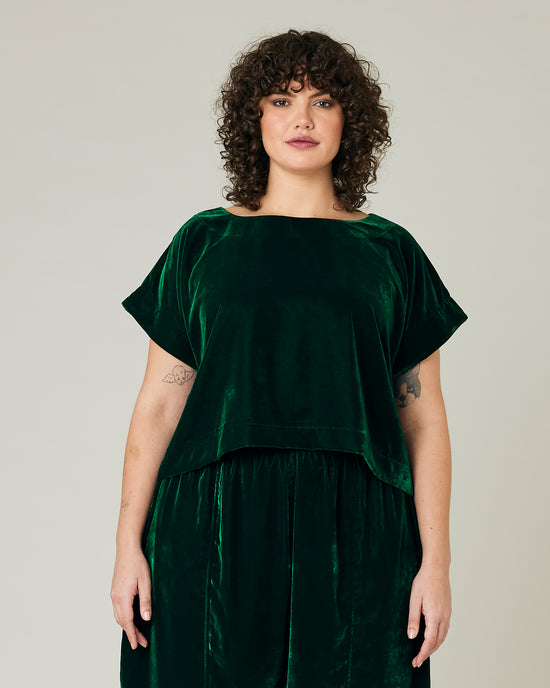 model wears green velvet polly top