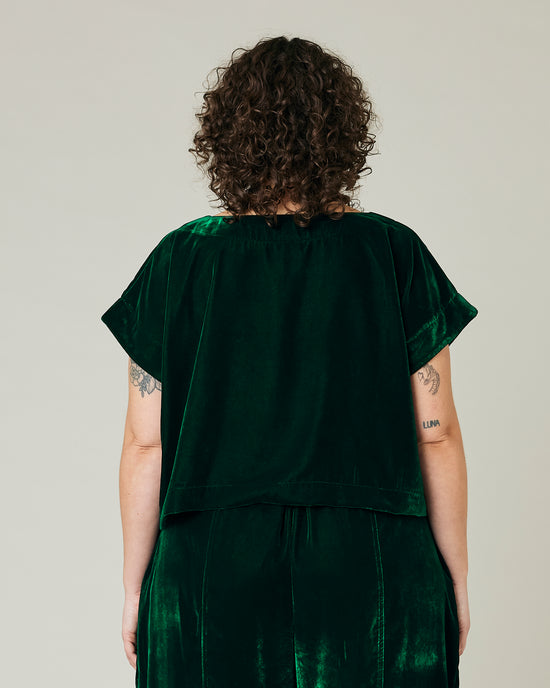 model wears green velvet polly top and mabel trousers