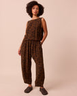 model wears mabel tiger print cupro trousers right
