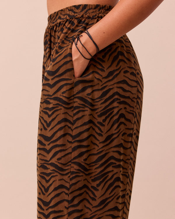 model wears mabel tiger print cupro trousers