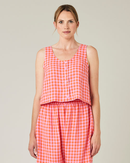 model wears pink and tomato check betty top