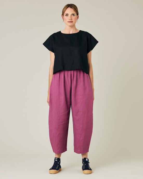 model wears dahlia pink linen mabel trousers