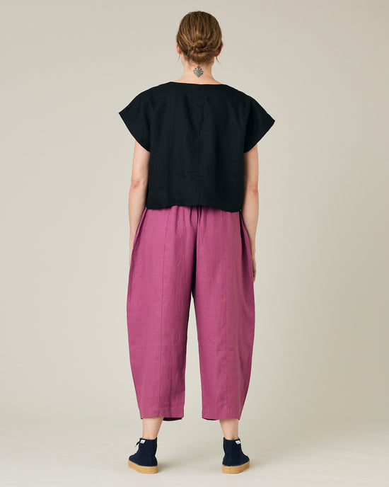 model wears dahlia pink linen mabel trousers