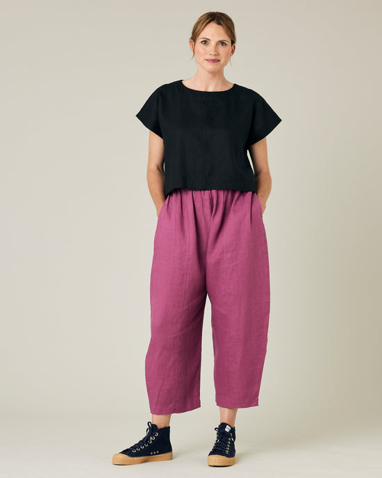 model wears dahlia pink linen mabel trousers