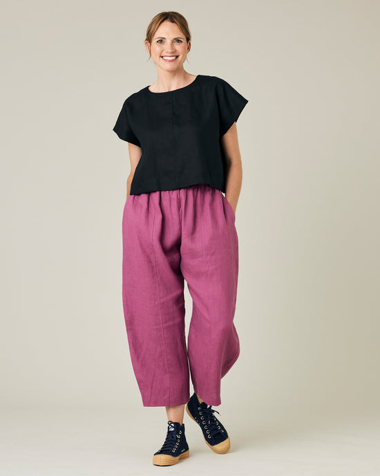 model wears dahlia pink linen mabel trousers