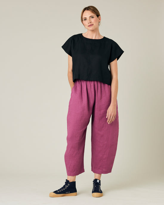 model wears dahlia pink linen mabel trousers