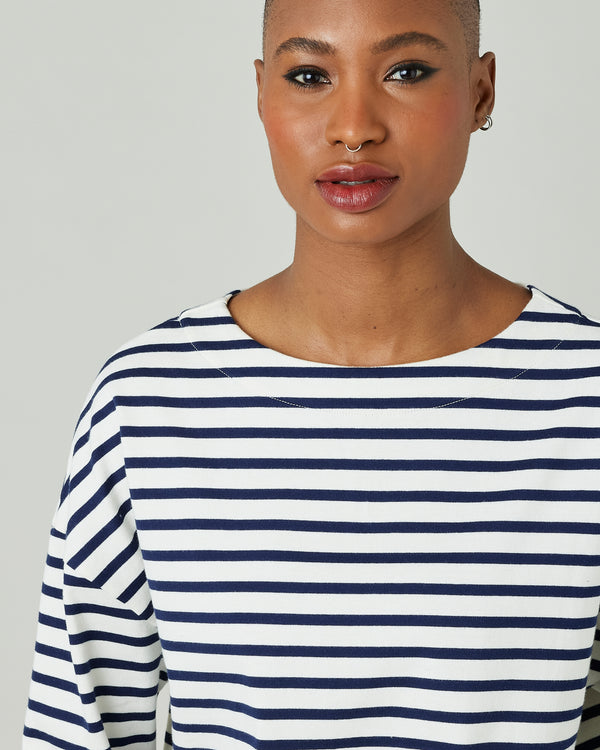 model wears ecru and navy striped breton top