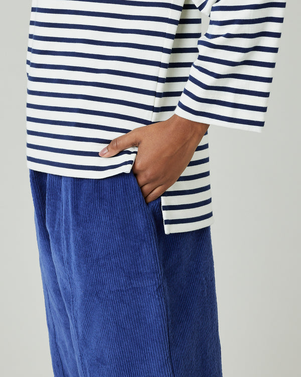 model wears ecru and navy striped breton top