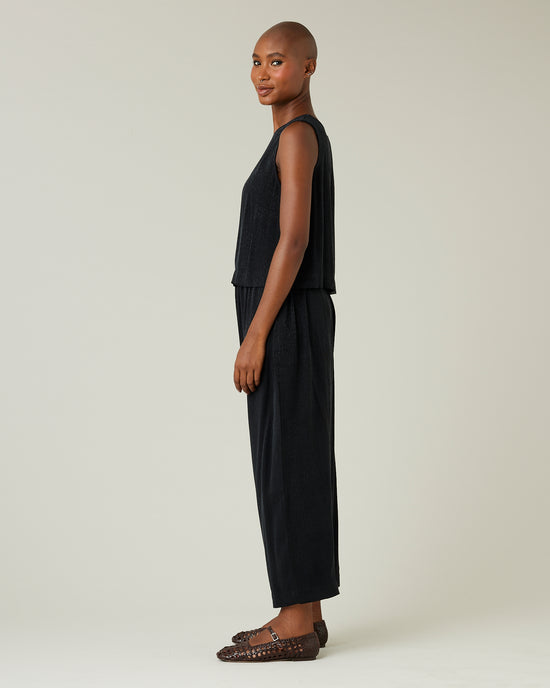 model wears black self leopard cupro mabel trousers