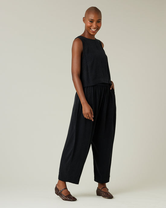 model wears black self leopard cupro mabel trousers