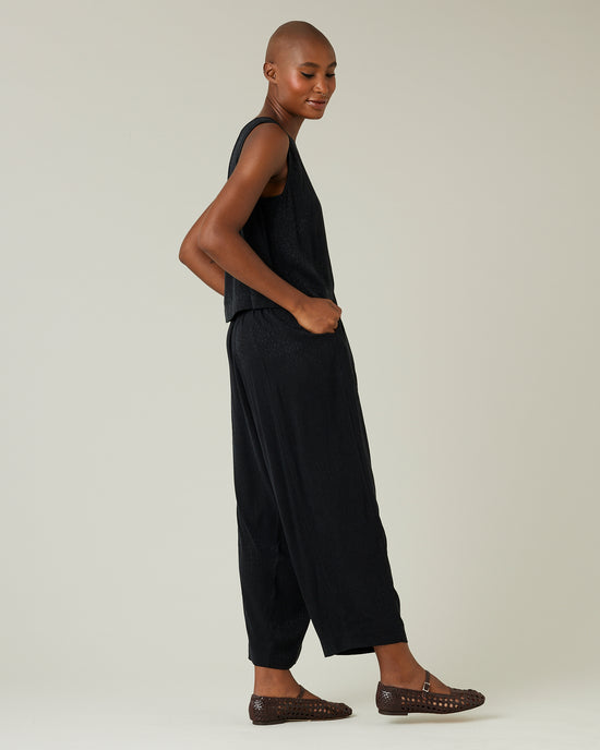 model wears black self leopard cupro mabel trousers