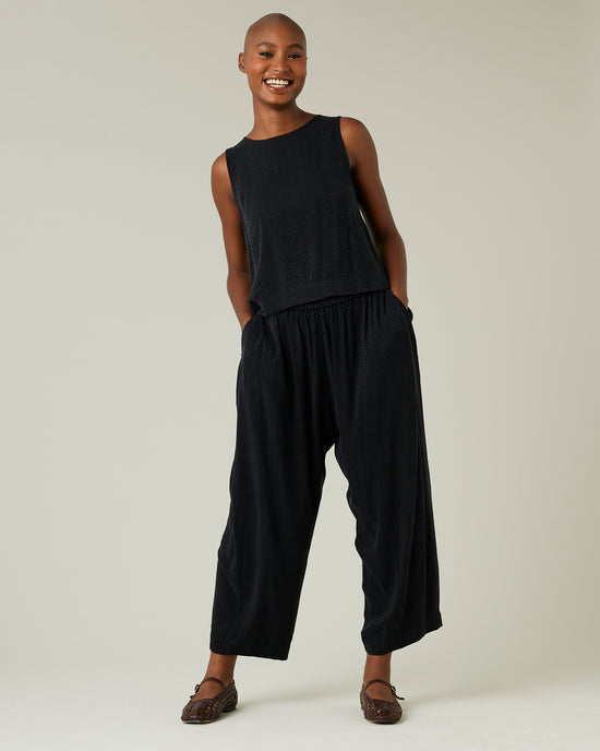 model wears black self leopard cupro mabel trousers