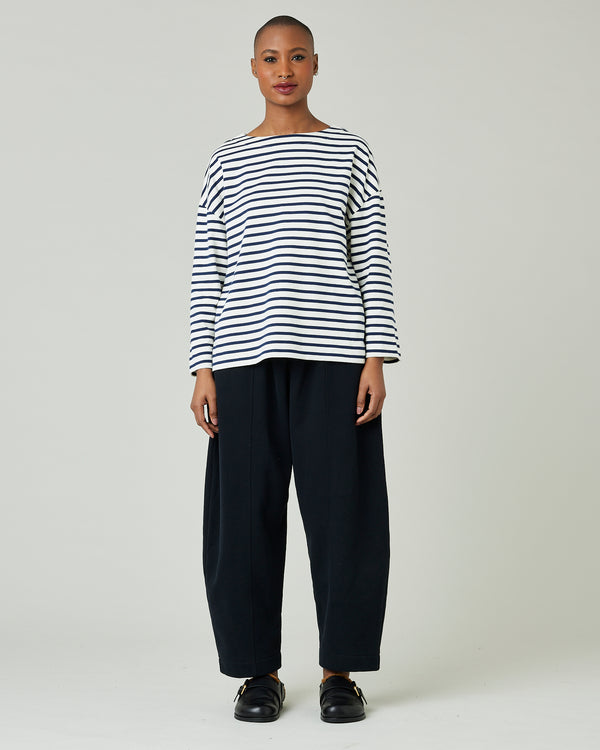 model wears ecru and navy striped breton top