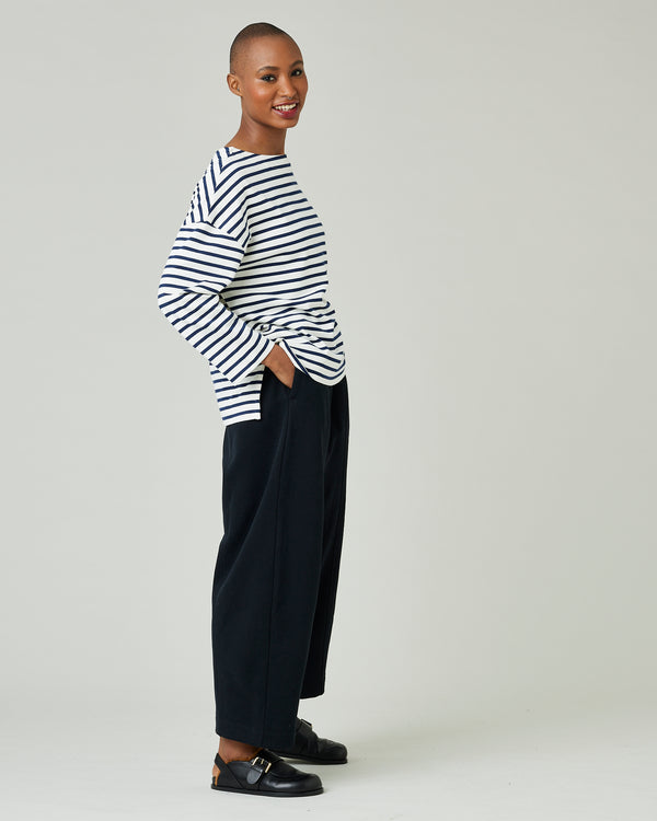 model wears ecru and navy striped breton top