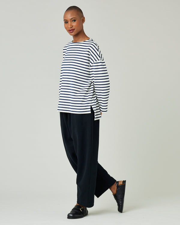 model wears ecru and navy striped breton top