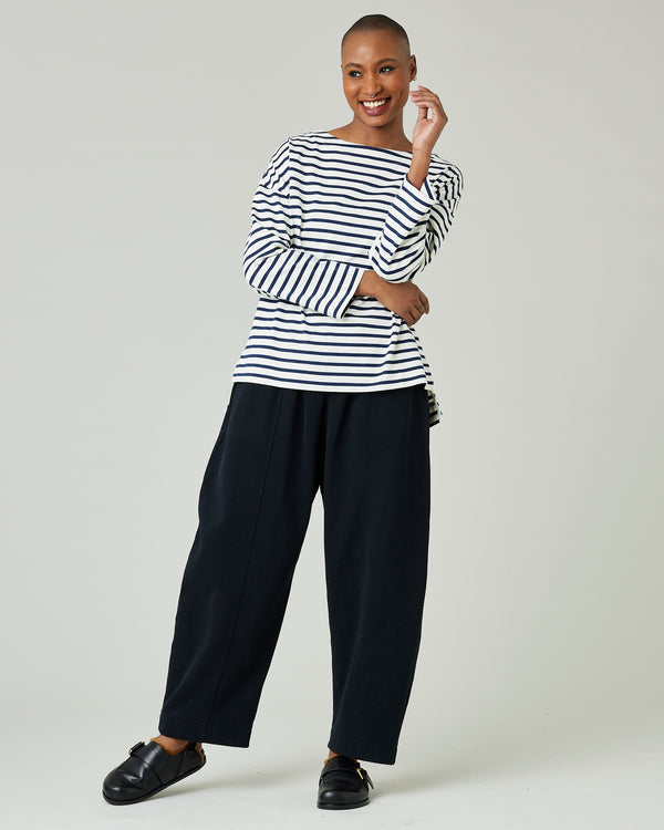 model wears ecru and navy striped breton top