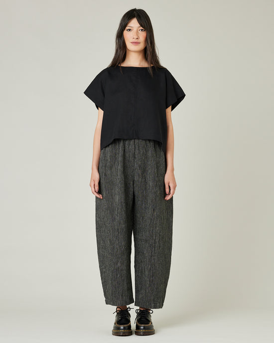 model wears black and ecru pencil stripe linen mabel trousers