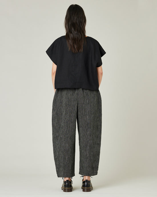 model wears black and ecru pencil stripe linen mabel trousers