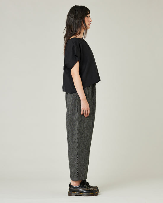 model wears black and ecru pencil stripe linen mabel trousers