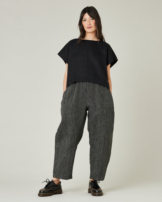 model wears black and ecru pencil stripe linen mabel trousers