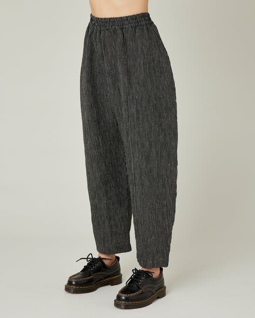 model wears black and ecru pencil stripe linen mabel trousers left